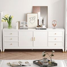 a living room with white furniture and flowers