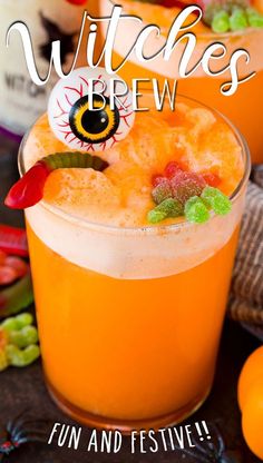 two glasses filled with orange juice and garnished with gummy eyeballs for halloween