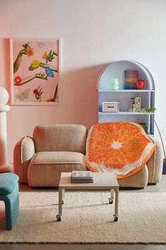 a living room filled with lots of furniture next to a wall mounted art piece on the wall