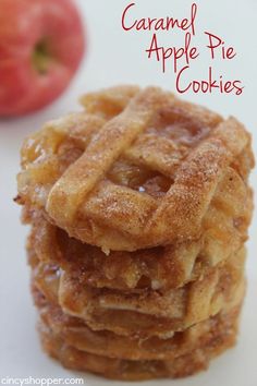 a stack of waffles sitting on top of a white plate next to an apple