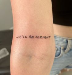 a woman's arm with the words we'll be alright tattooed on it