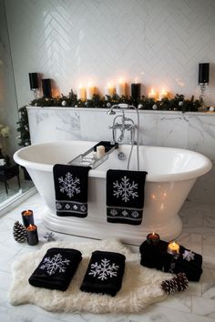 a white bath tub sitting on top of a bathroom floor next to candles and decorations