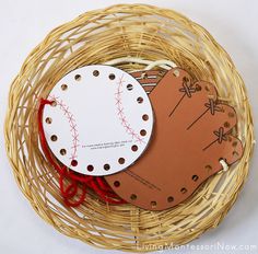 a basket filled with paper cut outs and some baseballs on top of each other