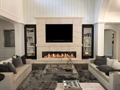 a living room with two couches and a fireplace