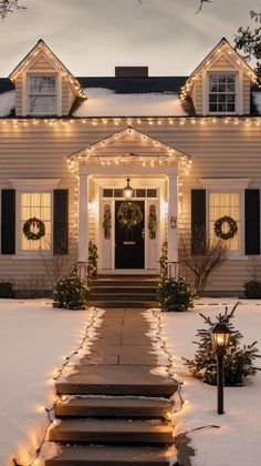 a white house with christmas lights and wreaths