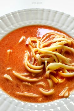 a white plate topped with pasta and sauce