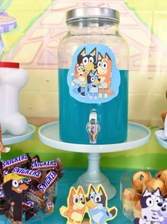 there is a jar with cartoon characters on it next to other toys and candies