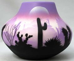 a purple and black vase with cactus silhouettes on it