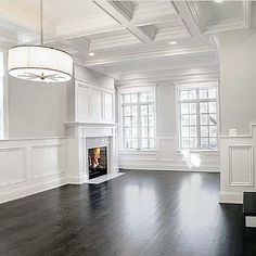 an empty living room with white walls and wood flooring is pictured in this image