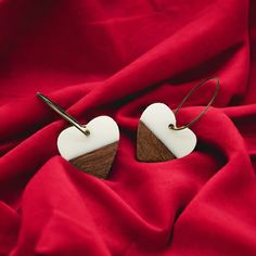 White Wood Heart Earrings These wood and resin heart hoop earrings carry a classic, minimalist vibe. They are funky and fun and so comfortable to wear as they are very lightweight.  The earrings are 1 inch wide with a total drop length of 1 & 3/4 inches.  Antique brass hoops with latch backs.  Lead and nickel free. Minimalist White Earrings For Valentine's Day, White Heart Pendant Earrings As Gift, White Heart Pendant Earrings For Gifts, Resin And Wood Earrings, Minimalist Vibe, Wood And Resin, Earrings Resin, Heart Hoop Earrings, Earrings Heart