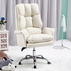 a white leather office chair sitting on top of a fluffy rug next to a stuffed animal