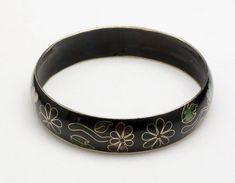 Vintage Cloisonne Enameled Bangle Bracelet-Black background with floral motif-Dark reds, pinks, and greens make up this fine enamel work-Interior circumference 8.2"-Width: .6"-Very good vintage condition, a little wear to the enamel on the inside edges, otherwise a very nice bangle Black Enamel Bracelet Jewelry, Black Enamel Bangle Bracelet, Black Enamel Bracelet Gift, Black Enamel Bracelets Gift, Black Enamel Bracelets For Gifts, Vintage Black Hand Painted Jewelry, Vintage Black Hand-painted Jewelry, Bracelet Flowers, Enamel Bangle