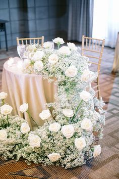 the table is set with white flowers and chairs for an elegant wedding reception at the four seasons hotel