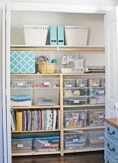 an organized closet with plastic bins, baskets and other crafting supplies on shelves