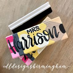 a wooden sign that says, mrs harrison on it and is next to a pair of scissors