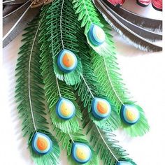 the feathers are decorated with blue and green decorations