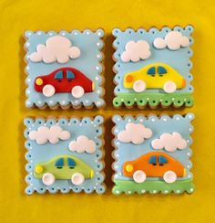 four decorated cookies in the shape of cars