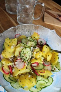 a salad with cucumbers, radishes and onions