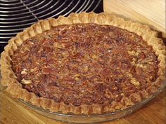 a pecan pie sitting on top of a wooden table