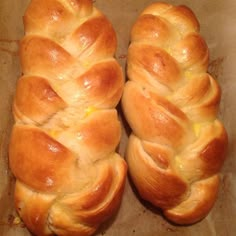 two loaves of bread sitting on top of a pan