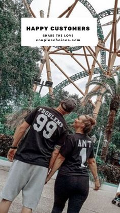 two people standing next to each other in front of a roller coaster with the words happy customers on it