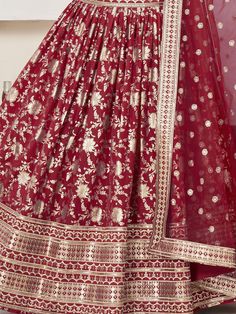 Introducing our stunning "glamorous red zari embroidered jacquard wedding lehenga choli" that is sure to make you stand out at any wedding or special occasion. This exquisite ensemble features a red color jacquard lehenga with intricate zari embroidered work and sequin work, paired with a matching jacquard choli and net dupatta. The lehenga is semi-stitched up to 42 inches, allowing for a perfect fit, while the choli comes as unstitched material for customization. The net dupatta with four side Jacquard Lehenga, Lehenga Crop Top, Floral Lehenga, Lehenga Choli Wedding, Reception Sarees, Reception Gown, Wedding Lehenga Choli, Maroon Saree, Golden Saree