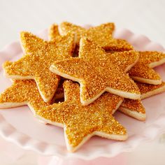 some cookies are arranged on a pink plate