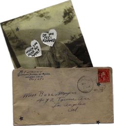 an old envelope with two hearts on it and some other letters in the mail box