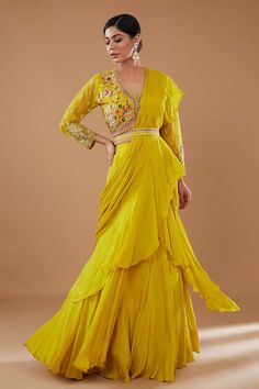 Mustard can can attached draped ruffle lehenga saree in layered silhouette, embellished by sequins. Comes with padded floral embroidered blouse and embellished belt. - Aza Fashions Fitted V-neck Wedding Sets, Bollywood V-neck Dress With Sheer Dupatta, Traditional V-neck Dresses For Reception, V-neck Wedding Dress For Diwali, Silk Draped Sharara For Wedding, Draped Silk Sharara For Wedding, Wedding Anarkali Set With Ruffles For Eid, Silk V-neck Traditional Wear For Wedding, Fitted V-neck Anarkali Sets