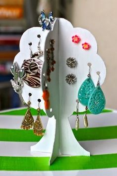 there are several different pictures of earrings in the same photo, and one has an earring holder