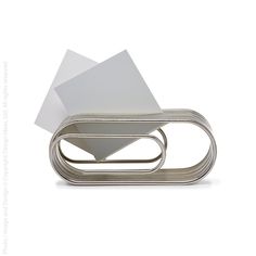 a white paper holder sitting on top of a metal object with papers sticking out of it