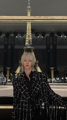 a woman standing in front of the eiffel tower