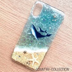 a phone case with a dolphin and starfish on it