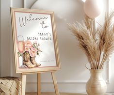 a welcome sign next to a vase with flowers