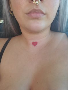 a close up of a woman's face with a nose ring on her nose