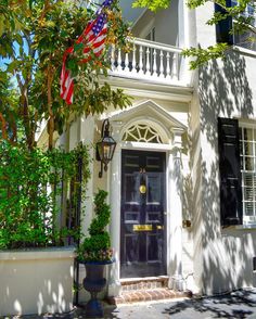 a white house with an american flag on the front door