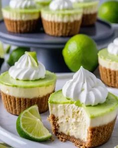 lime cheesecakes with whipped cream on top and limes in the back ground