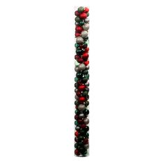 a tall glass tube filled with christmas ornaments