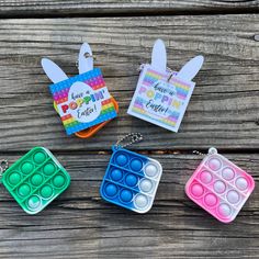 four different colored trays with eggs in them on a wooden table next to each other