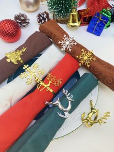 the napkins are decorated with gold reindeer and snowflakes on them, along with other holiday decorations