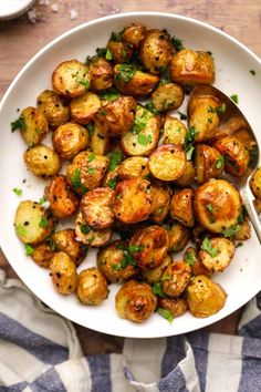 a white bowl filled with cooked potatoes on top of a table