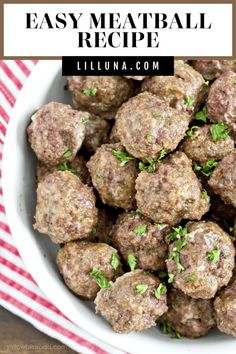 a white bowl filled with meatballs and garnished with parsley