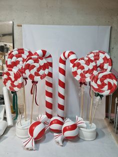 some candy canes and lollipops are on display