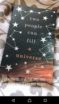 a book sitting on top of a bed covered in stars