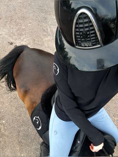 a person with a horse's head on the back of a motorcycle helmet and jacket