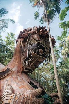 a large wooden animal statue in the middle of some trees