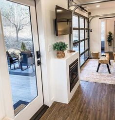 a living room with wood flooring and white walls is pictured in this image from the front door