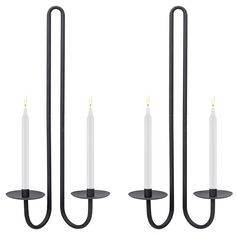 three candle holders with one light on each side and the other hanging from two black metal poles