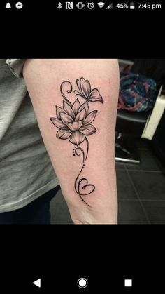 a black and white flower tattoo on the arm