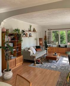 a living room filled with furniture and lots of windows